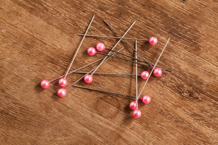 wood Background with sewing tools and colored thread 
