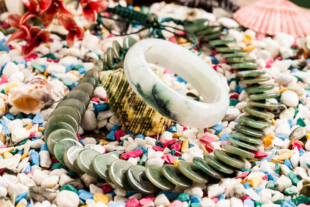 jade bracelet and jade necklace on stone background.の写真素材