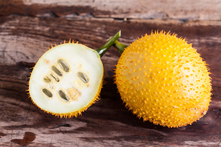 Gac,Baby Jackfruit Spiny Bitter Gourd, Sweet Gourd.A Southeast Asian fruit isolate on wood.