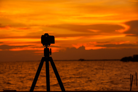 Camera silhouetted against the sea.の写真素材