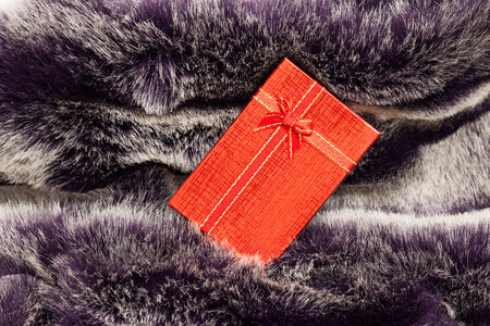 Red gift box on wool texture.の写真素材