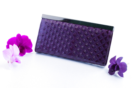 Woman Purple Purse (wallet) and Orchid isolated on the white background.の写真素材