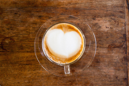 Cup of hot cappuccino coffee on wooden table.の写真素材