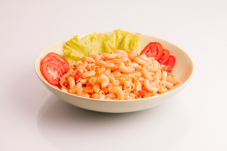 Fried macaroni with egg,chicken and vegetable in tomato sauce.の写真素材