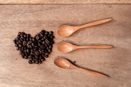 Coffee beans and bamboo spoon on wooden background.の写真素材