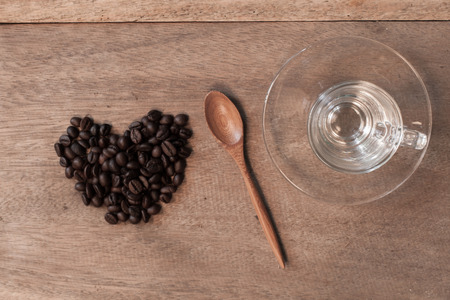 Coffee beans and bamboo spoon on wooden background.の写真素材
