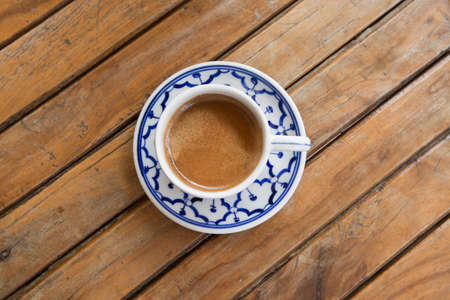 cup of espresso on a wooden background table.の写真素材