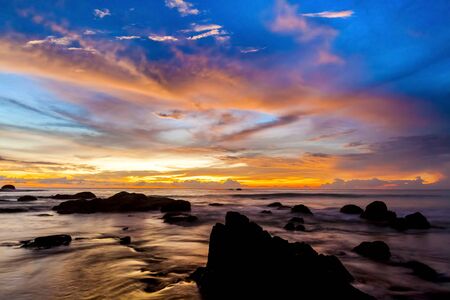 The colorful sunset at the stones beach.の写真素材