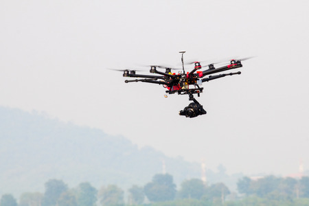 drone with professional camera flying.