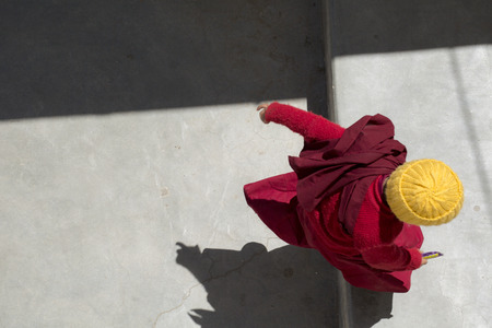 Buddhist monk in traditional robe at tibetan monastery in Leh Ladakh, Kashmir, Indiaの写真素材