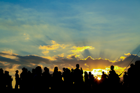 Silhouette of people on a sunsetの写真素材