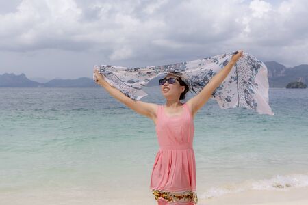 a woman so happy on beach in summer timeの写真素材