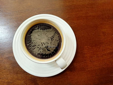 black coffee on wood backgroundの写真素材