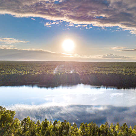 sunset on a forest lakeの写真素材