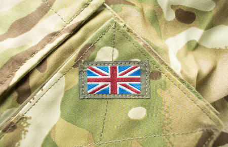 Union Jack / Union flag badge on a camouflage British army uniform. Text / writing space surrounding badge.の写真素材