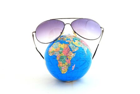 Globe with sunglasses isolated on the whiteの写真素材