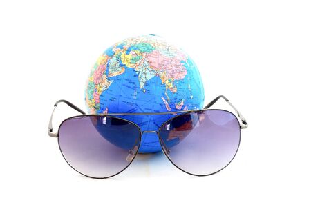 Globe with sunglasses isolated on the whiteの写真素材