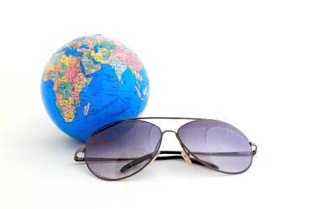 Globe with sunglasses isolated on the whiteの写真素材