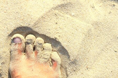 Close up of feet in sand
