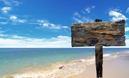 wood sign on beach and seaの写真素材