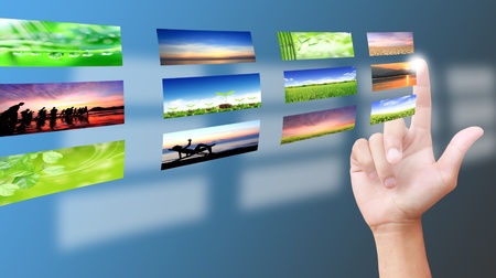 Male hand selecting images multimedia information flowの写真素材