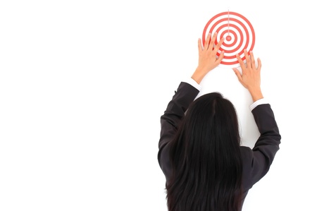 Businesswoman in a suit holds a dart boardの写真素材
