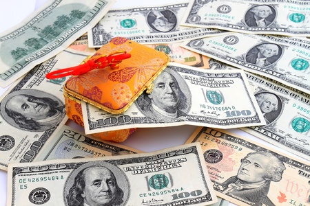 Dollar banknotes in a gold purse.の写真素材