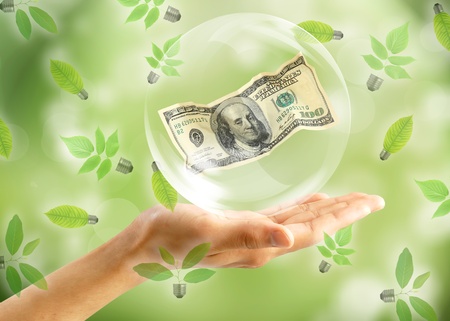 Eco concept : Hand with dollar in bubbles