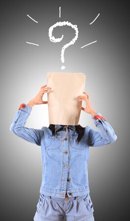 thinking business woman in front of question marks written blackboardの写真素材