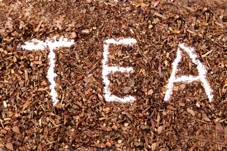 Green tea leaves isolated on whiteの写真素材