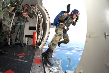 Sattaheep - SEPTEPBER 12: Thai navy parachute team jumps out of the airplane for show in Sunset...