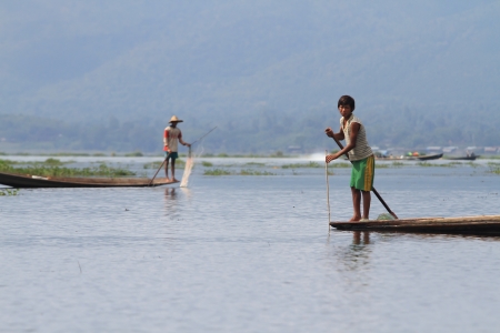 INLE LAKE, MYANMAR - NOVEMBER 18 : Fisherman catches fish for food on NOVEMBER 18, 2012 on Inle Lake, Myanmar. Intha people possess the leg-rowing style and the unique coop-like fishing equipmentのeditorial素材