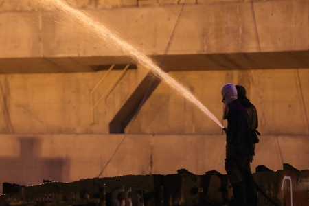 Silhouettes of  firemen before a fireの写真素材