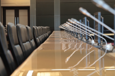 before a conference, the microphones in front of empty chairs