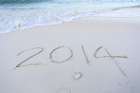 Year 2014 written in sand, on tropical beachの写真素材