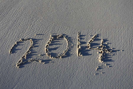 Year 2014 written in sand, on tropical beach
