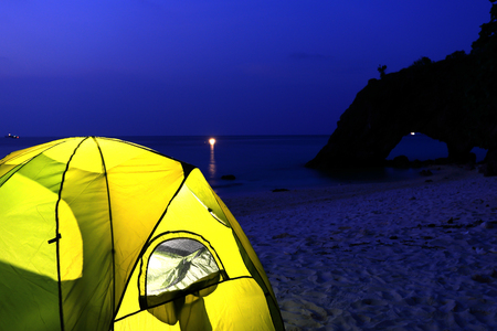 green tent on beach in sunsetの写真素材