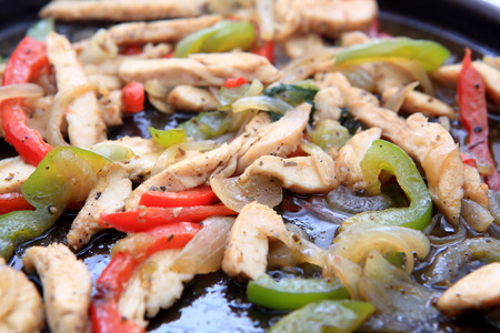 Hot skillet of chicken fajitas and vegetablesの写真素材