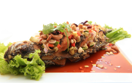 Fried snapper with chili sauce on the plateの写真素材