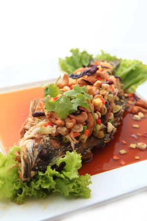 Fried snapper with chili sauce on the plateの写真素材