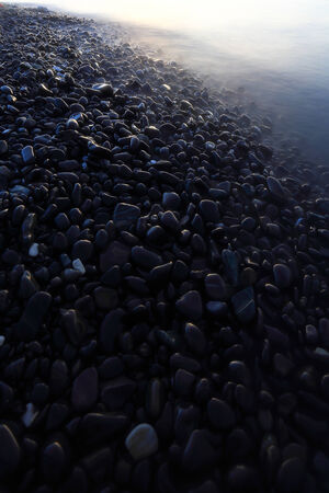 Twilight An island of smooth polished rocks in formationの写真素材