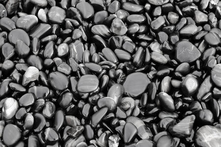 Colorful pebbles touching wave at beautiful rock island, called Koh Hin Ngam, near Lipe island, Thailandの写真素材