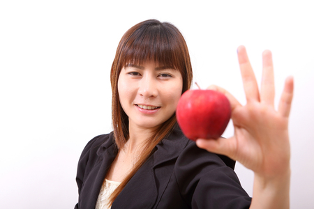 Beautiful young woman eating red apple with health teeth  Isolated over white background, asian beauty modelの写真素材