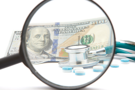 health care costs - Stethoscope on money backgroundの写真素材