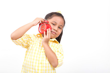 picture of girl holding alarm clock over white