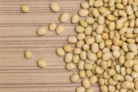 Dry soybeans on wooden boardの写真素材