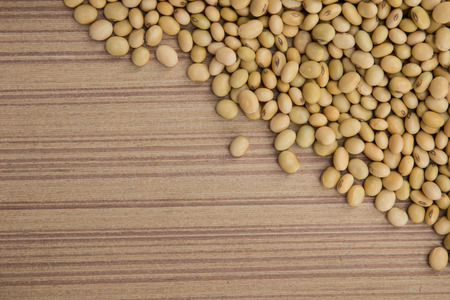 Dry soybeans on wooden boardの写真素材
