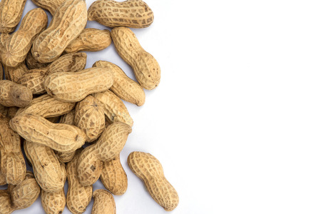 Dried peanuts in closeup on the white background