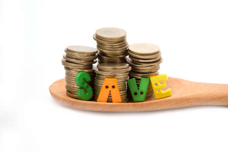 Coins  on wooden spoon isolated with white background.の写真素材