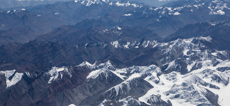 Himalaya mountains under clouds. View from the airplane. India, Ladakhの写真素材